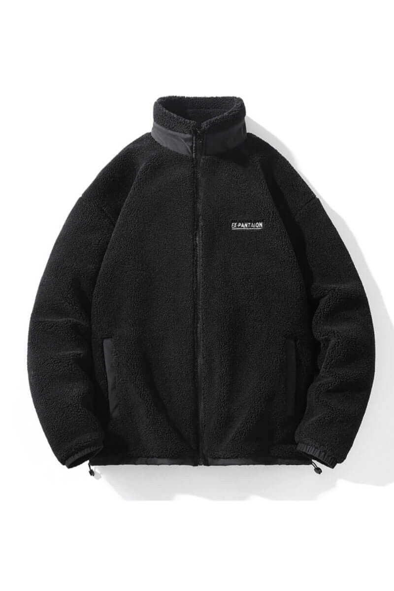 Black sherpa fleece zip-up jacket with high collar and chest logo patch