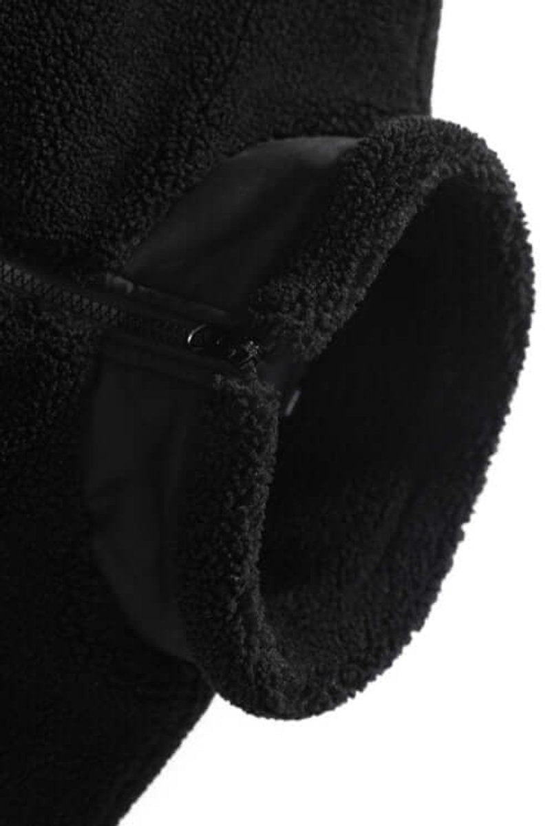 Close-up of black sherpa fleece cuff showing zip pocket detail