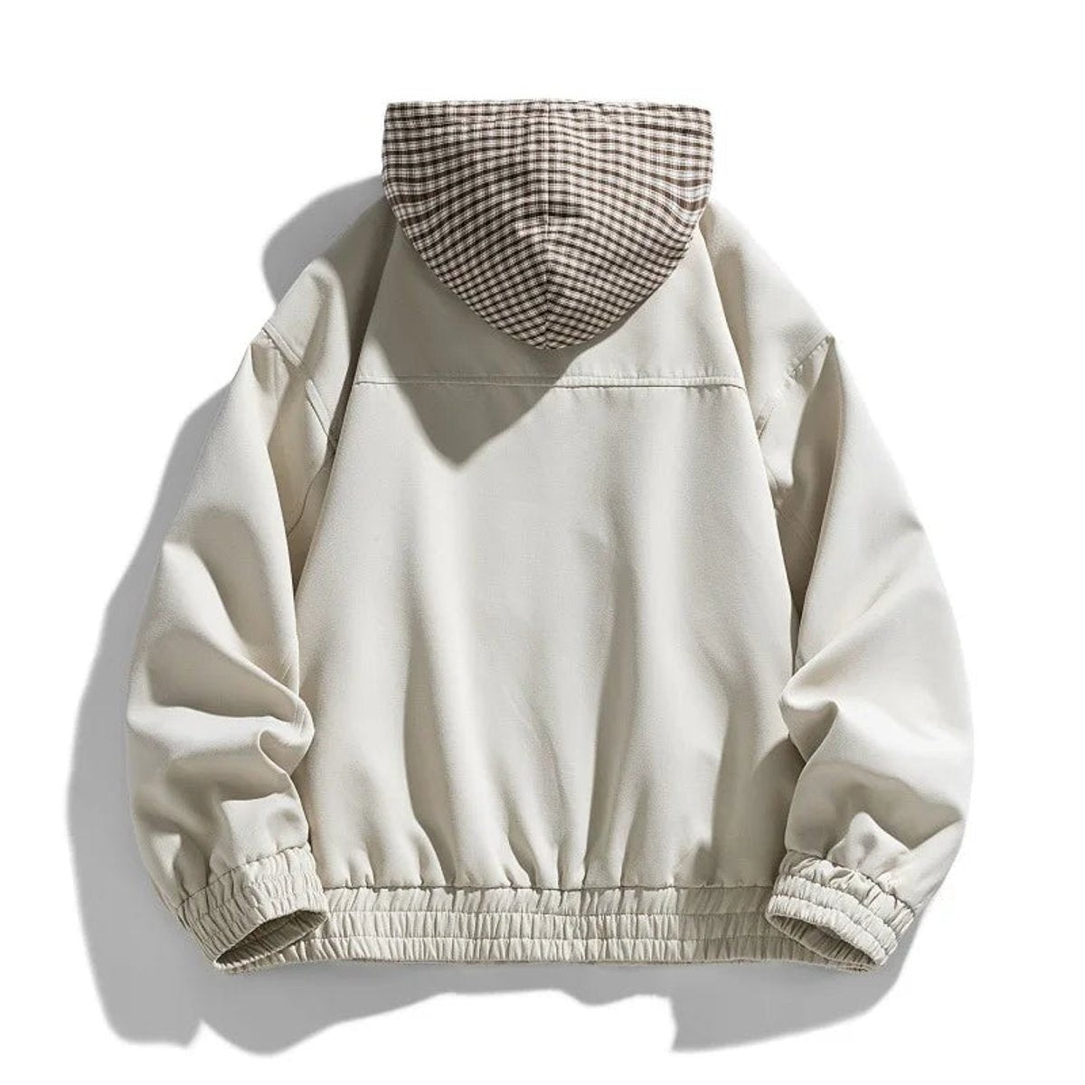 Rear view of cream bomber jacket showing plaid hood and elastic hem