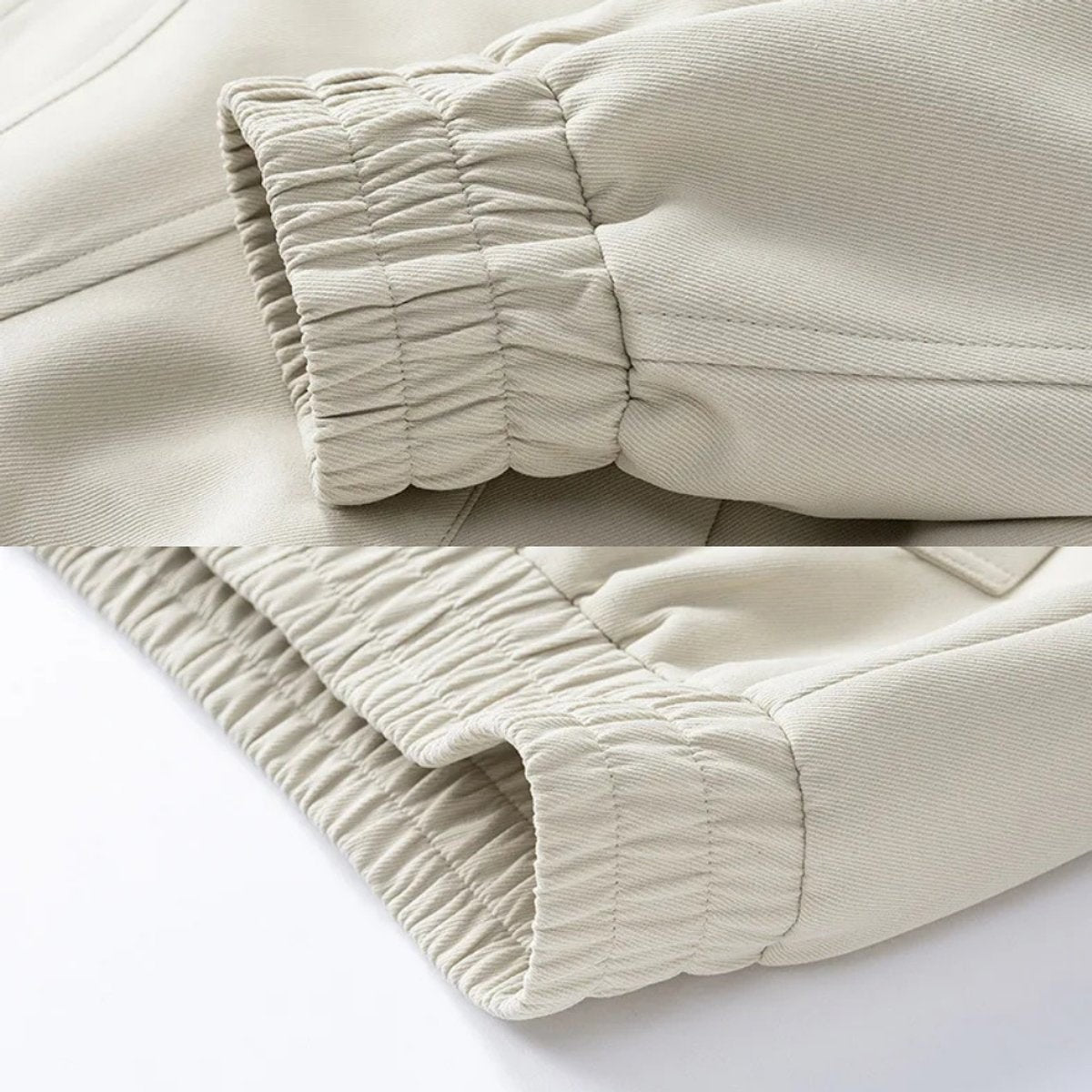 Detail shot of elasticated cuff and hem on cream bomber jacket