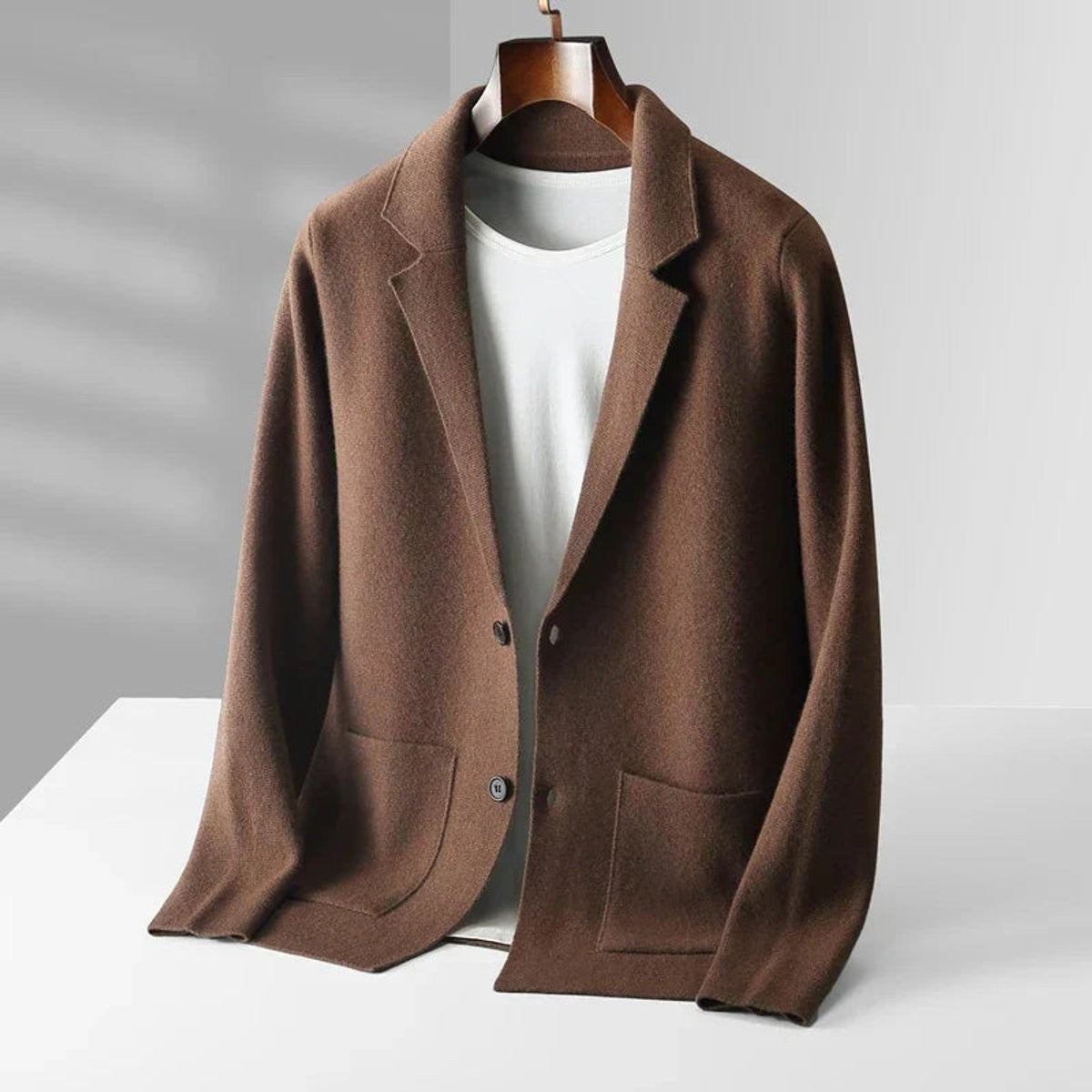 Brown knitted blazer cardigan with notch lapel and patch pockets on hanger