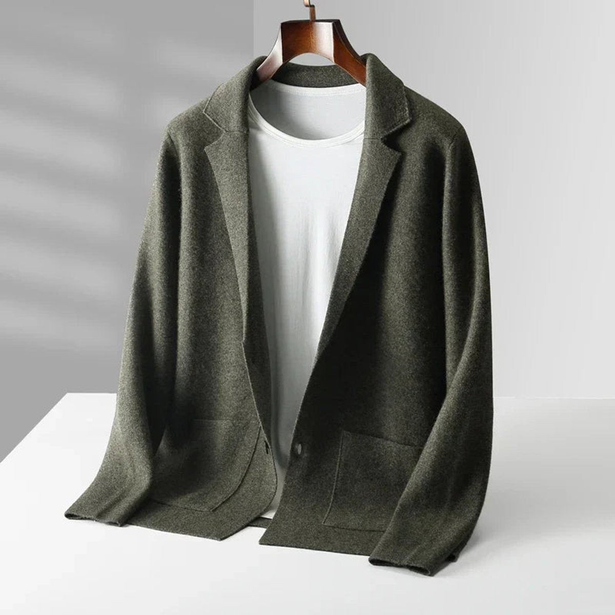Olive green knitted blazer cardigan with notch lapel worn over white tee