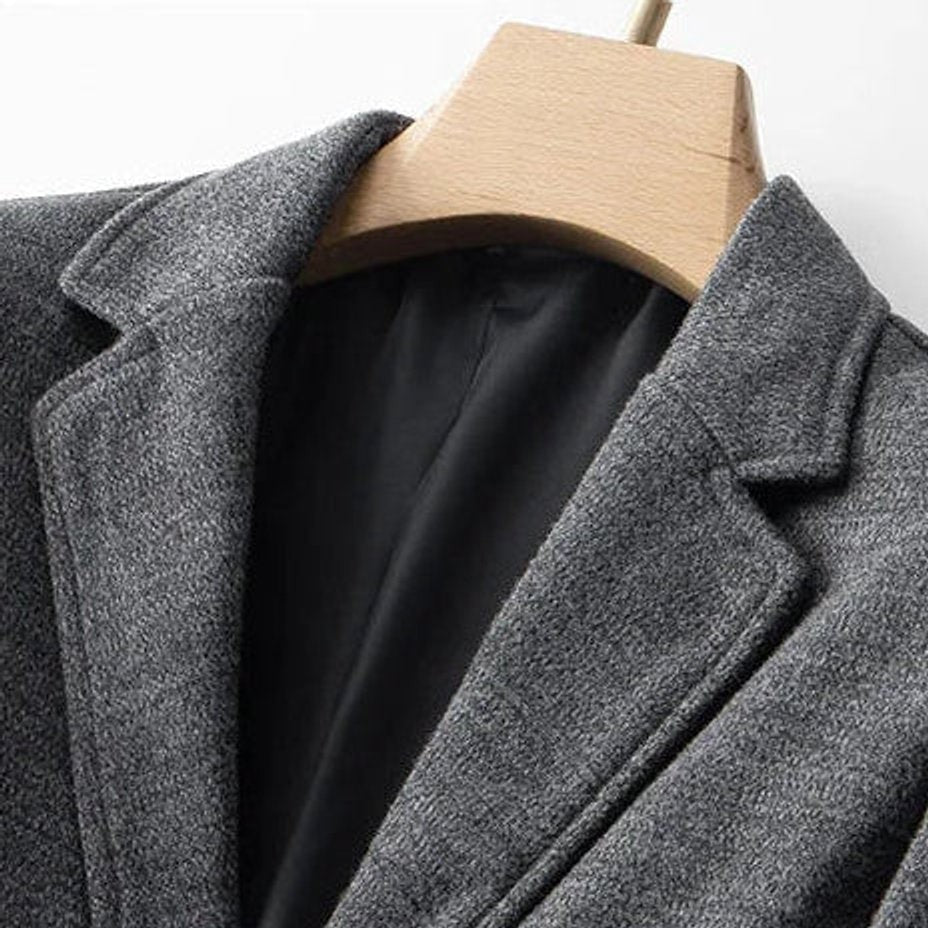 Close-up of notch lapel and black lining on grey wool-blend blazer