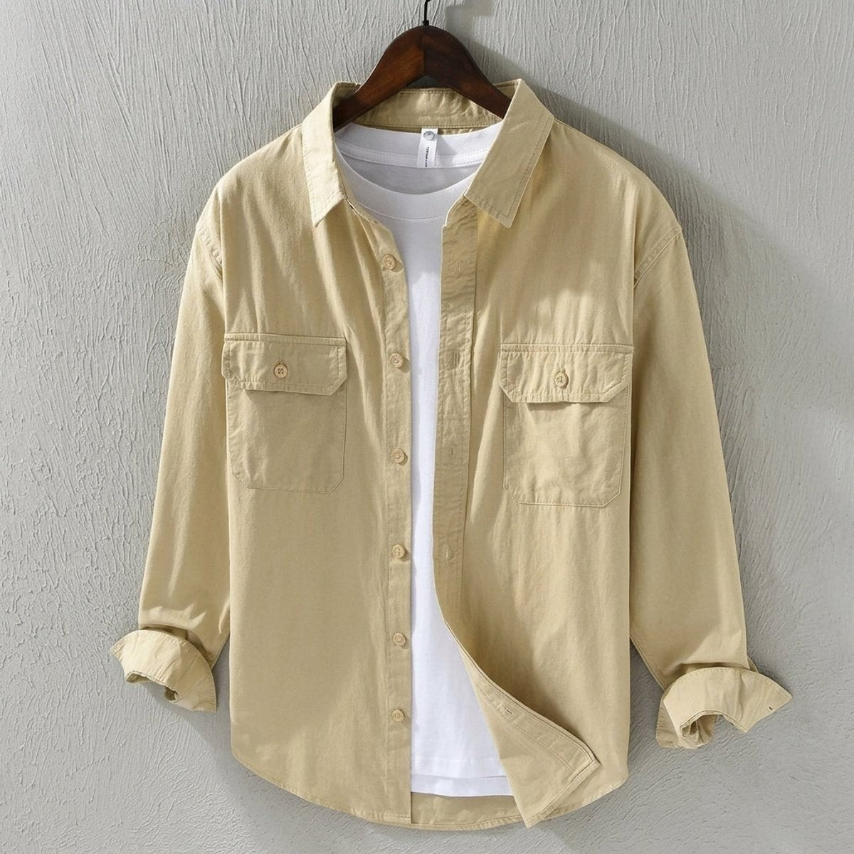 Beige cotton overshirt with twin chest pockets, layered over white t-shirt