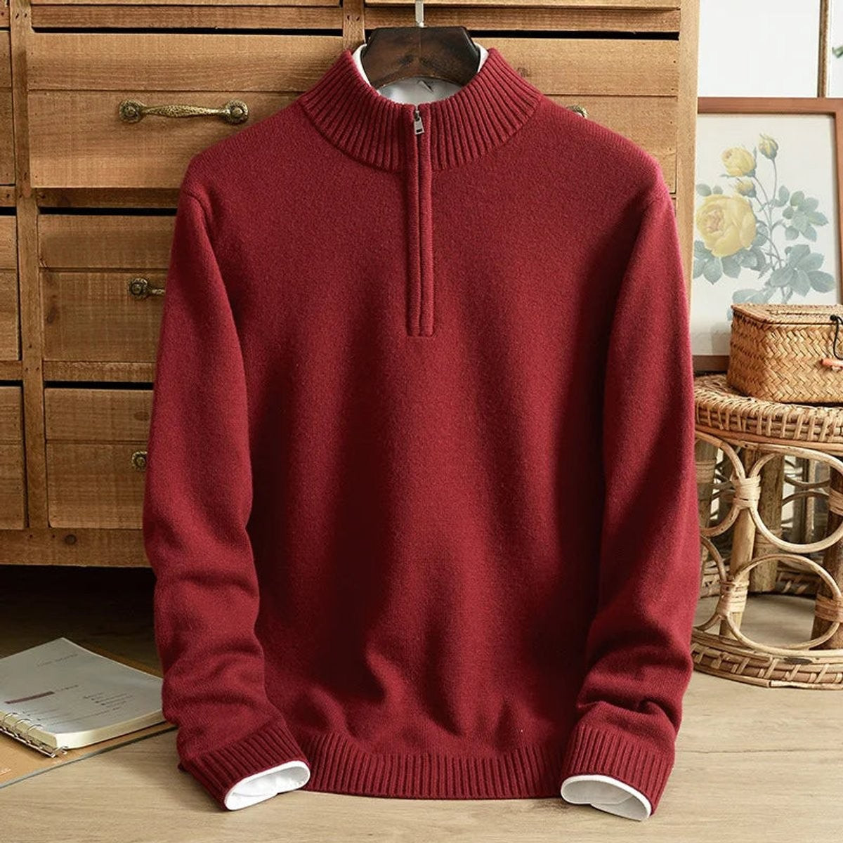Burgundy half-zip cashmere jumper displayed on wooden hanger