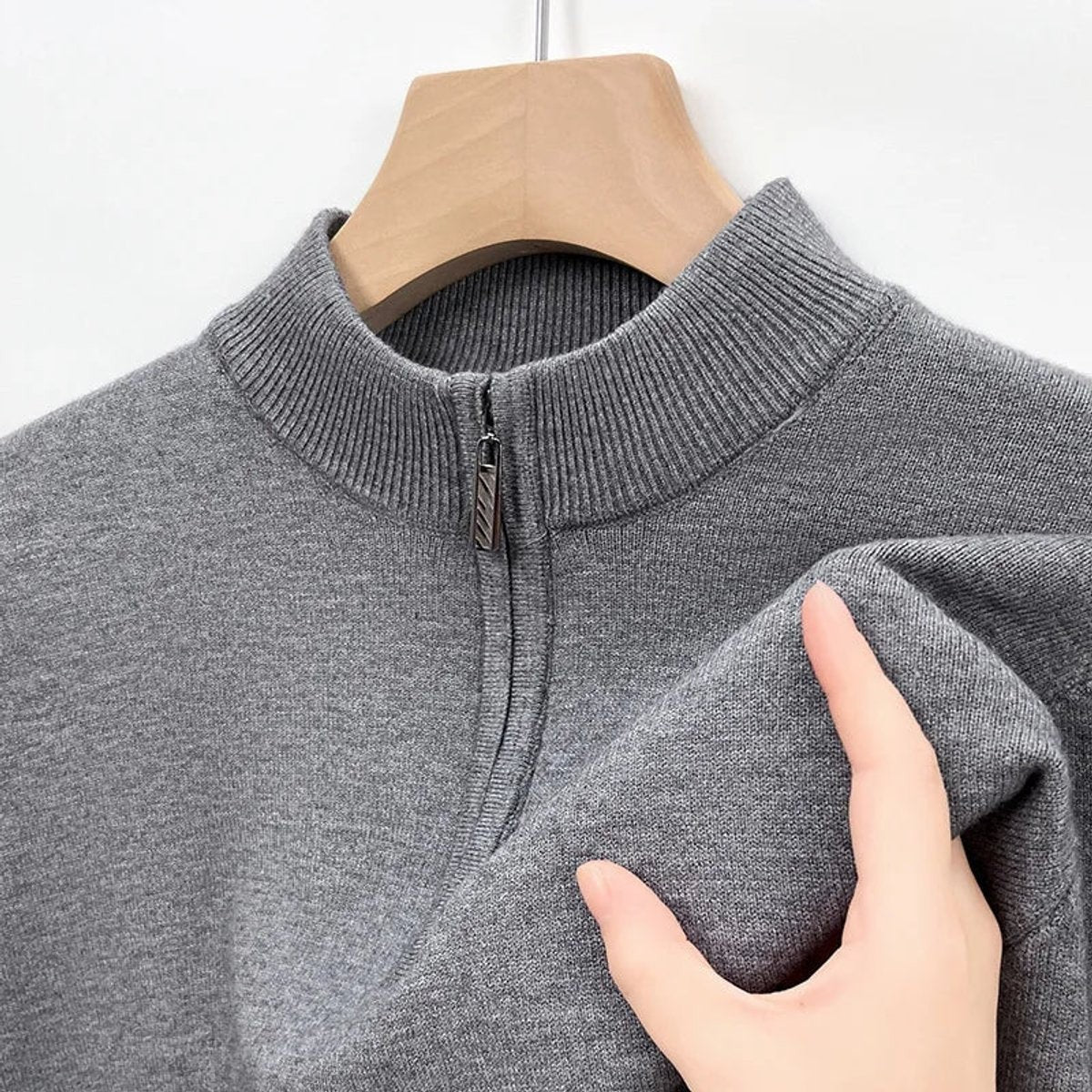 Grey half-zip jumper collar close-up highlighting ribbed knit finish