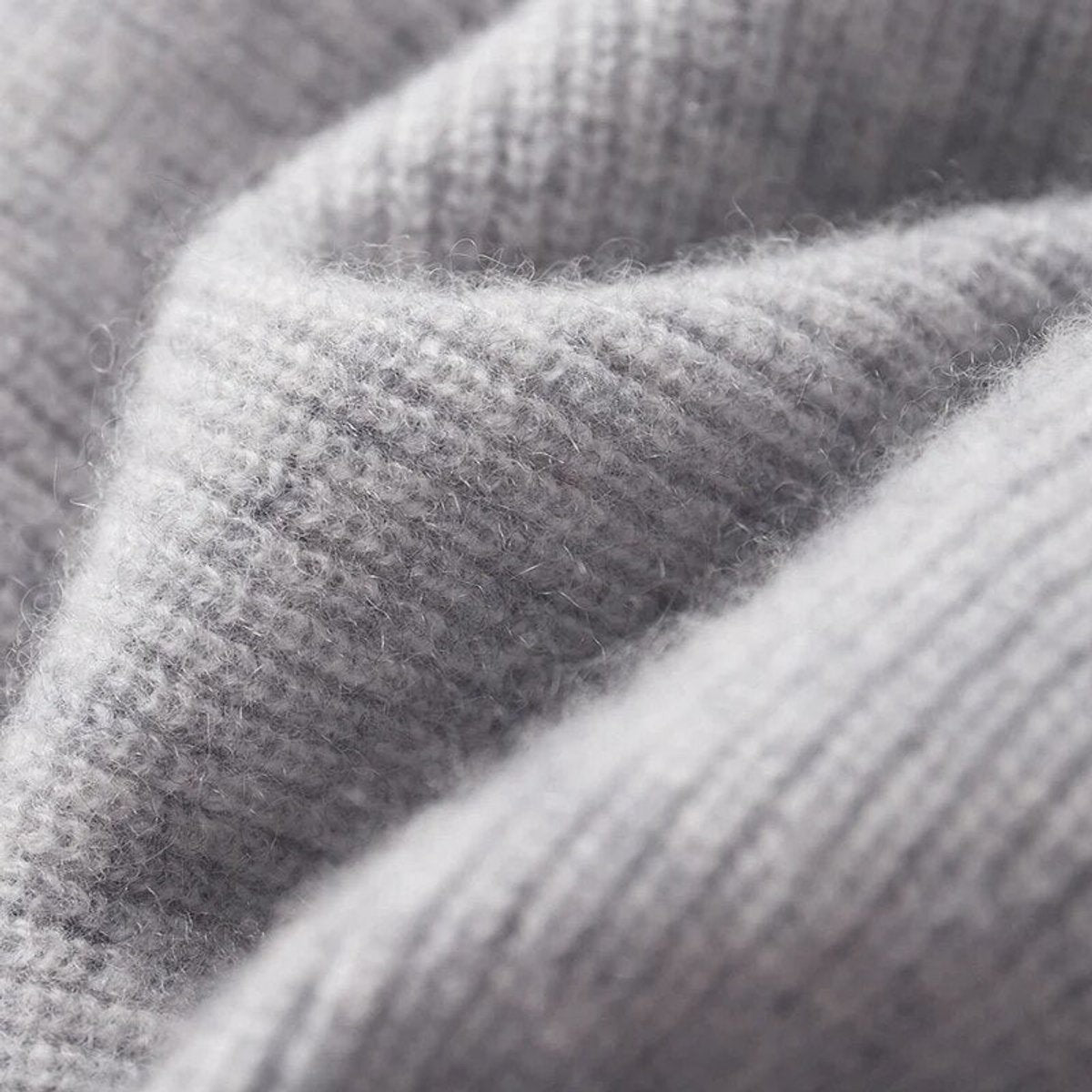 Close-up of grey ribbed knit fabric showing soft cashmere blend texture