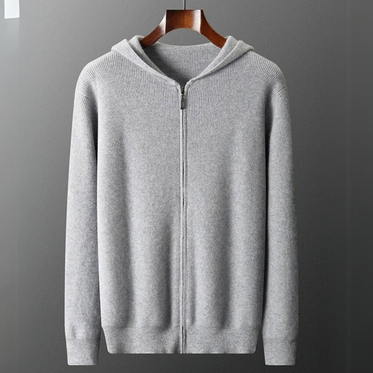 Grey knitted zip hoodie cardigan hanging, ribbed trim and full-length zip