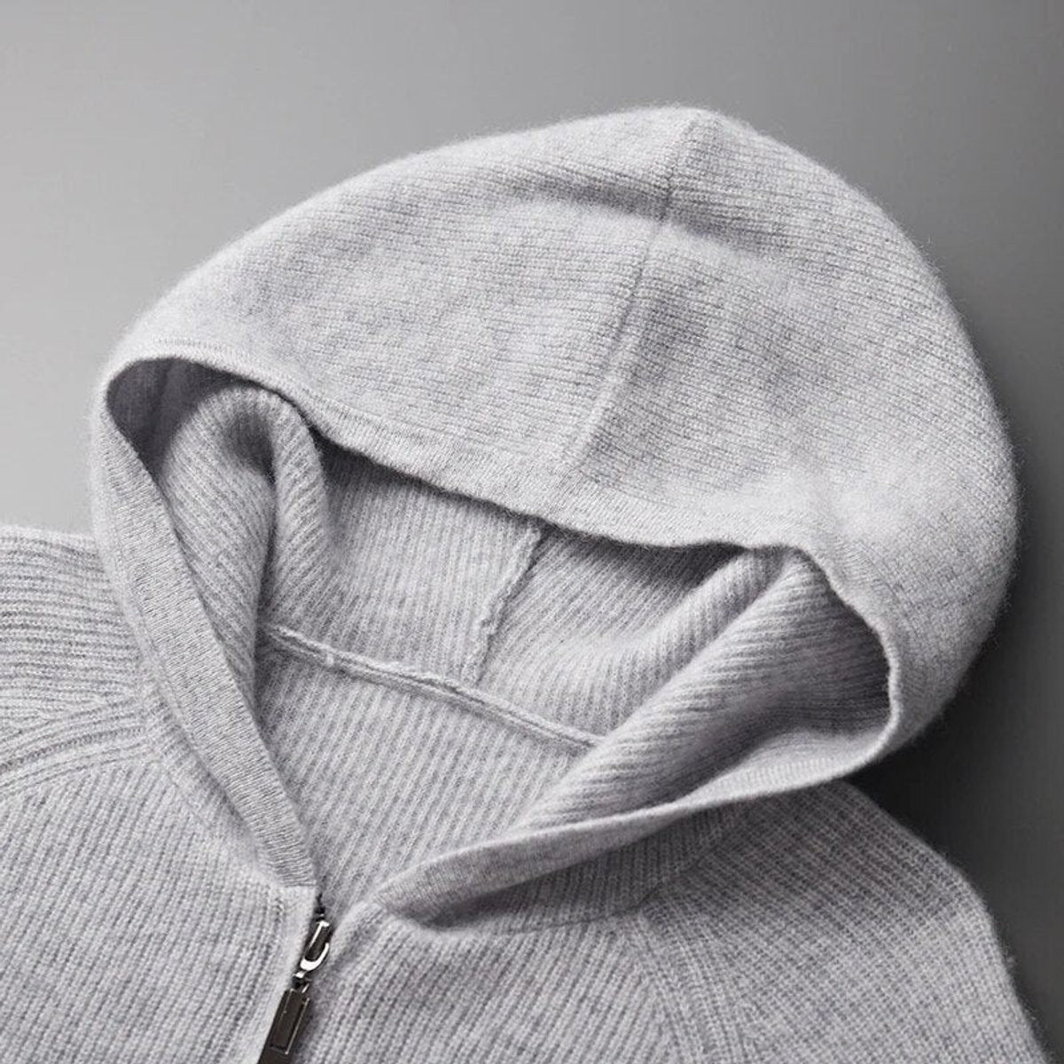 Close-up of hood on grey knitted cardigan jumper with ribbed knit detail