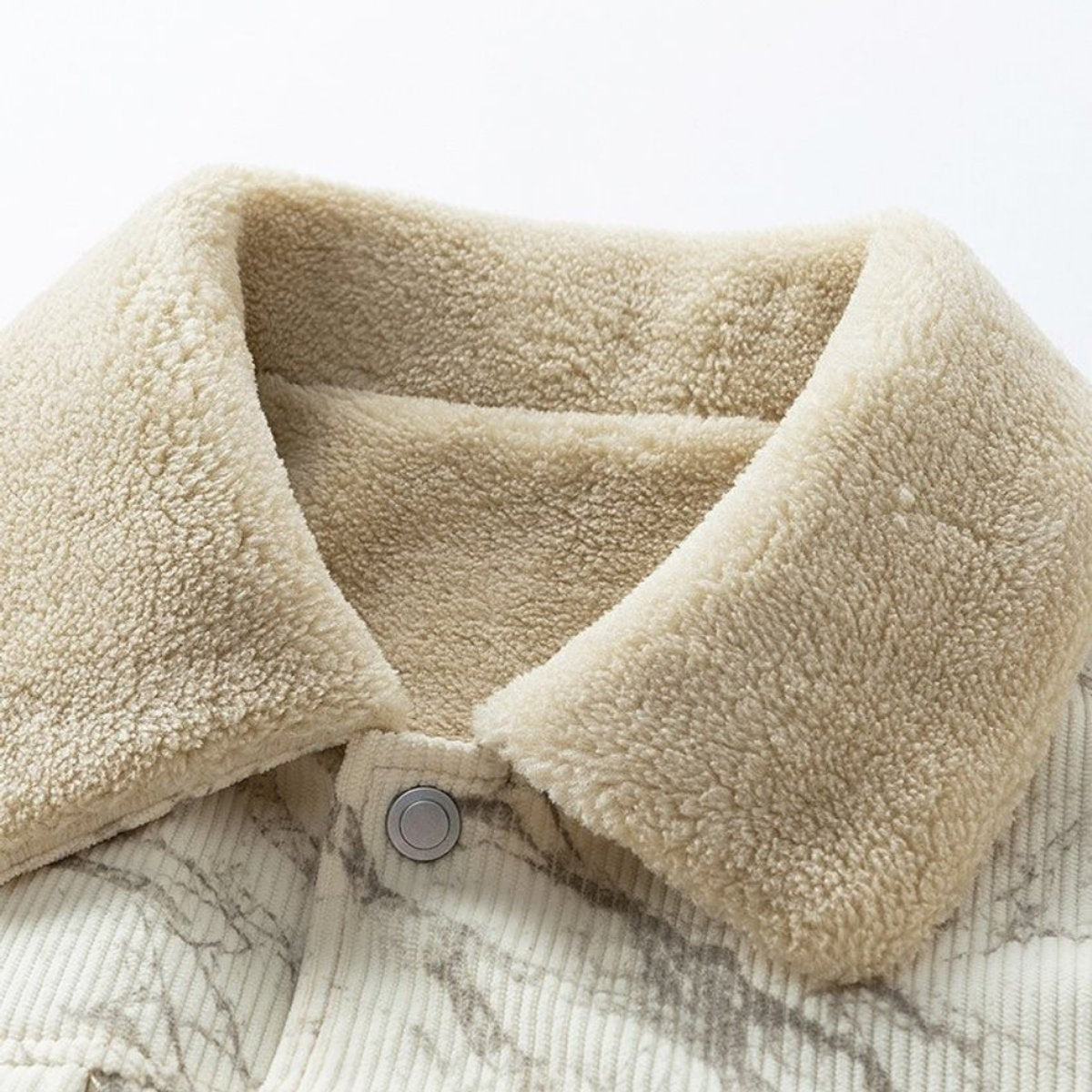 Close-up of cream sherpa collar on marble-print corduroy bomber jacket