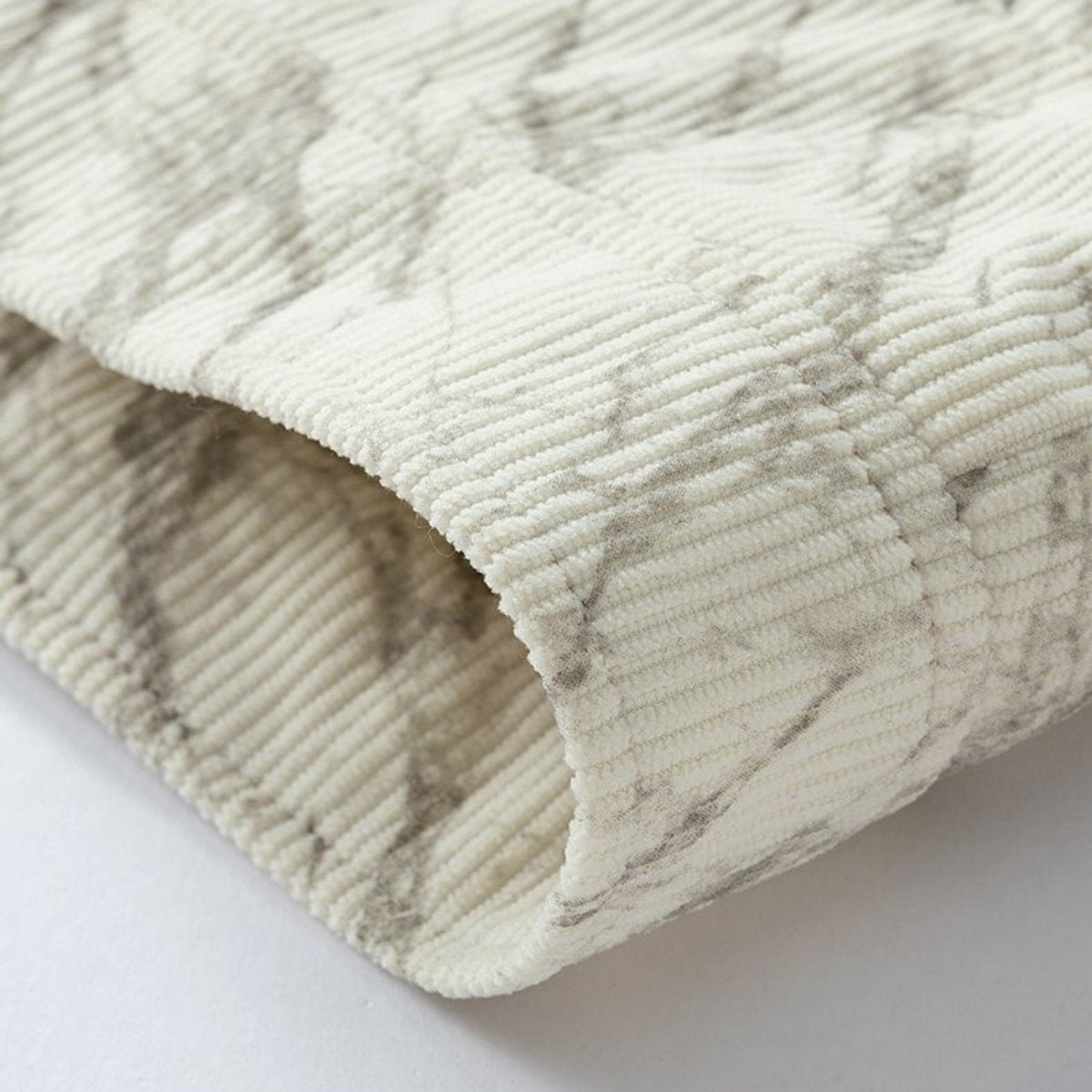 Folded cuff detail showing ribbed corduroy texture with subtle marble print