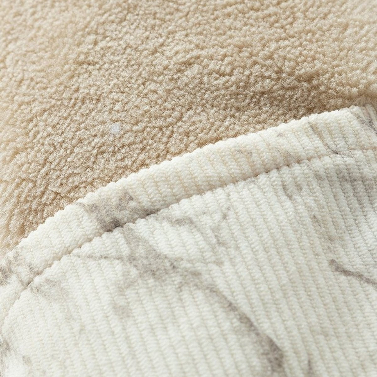Close-up contrast of soft sherpa fleece lining against corduroy jacket exterior