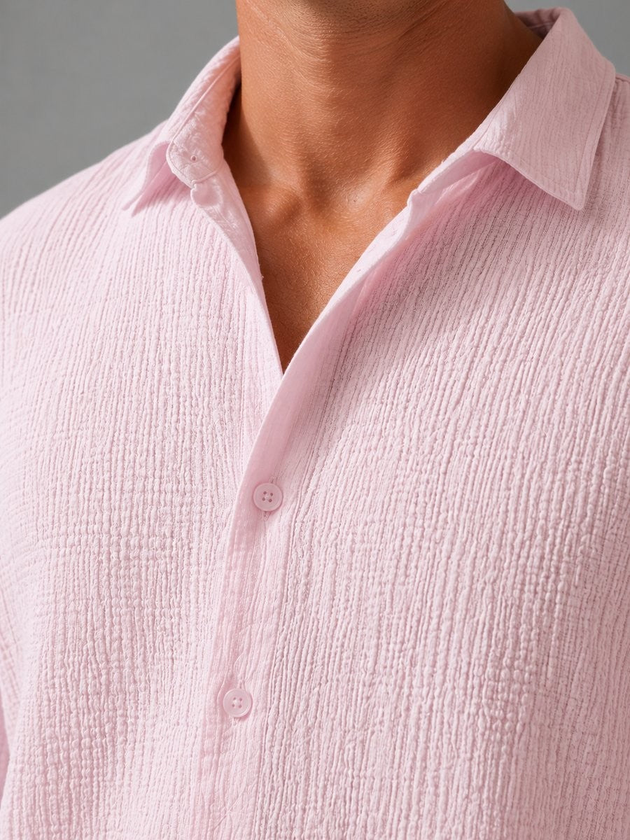 Close-up of pink textured cotton shirt collar and button placket