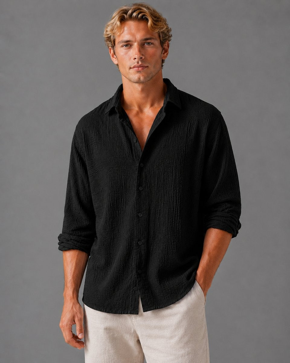 Black textured long-sleeve shirt with relaxed fit and rolled sleeves