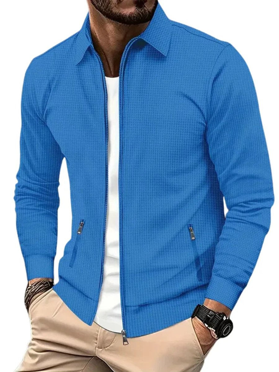 Blue waffle-knit zip-up jacket featuring long sleeves and zip pockets