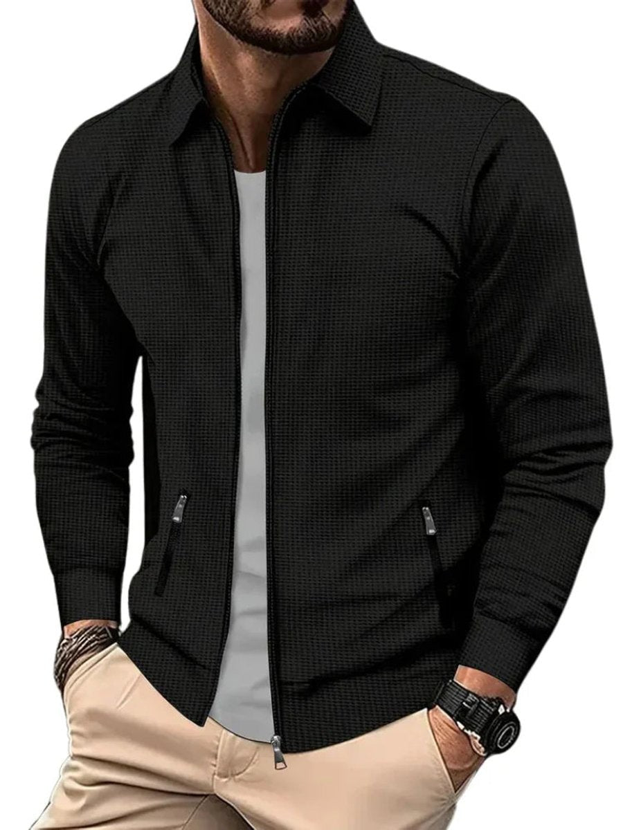 Black waffle-knit zip-up jacket with ribbed cuffs and zip pockets