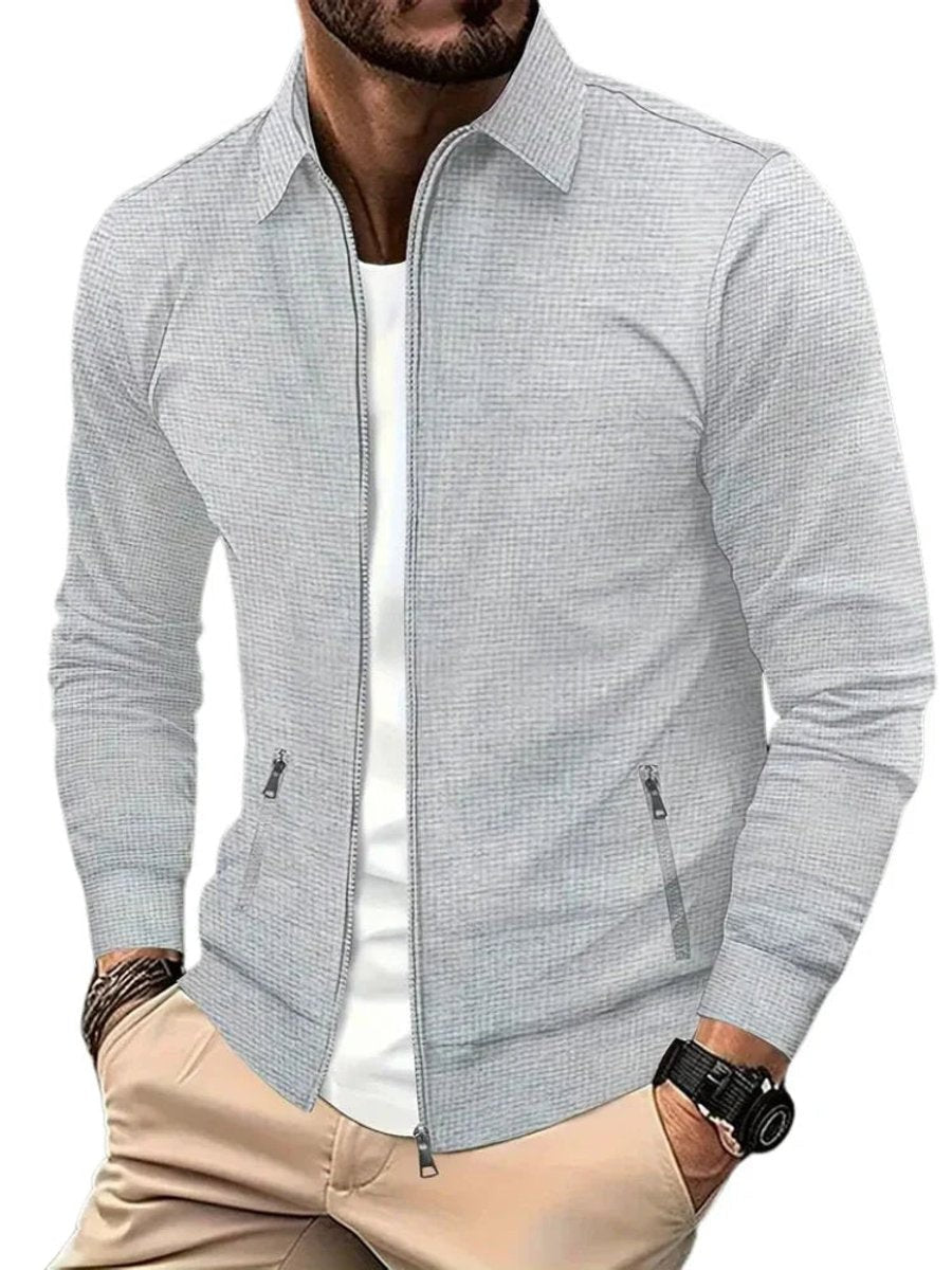 Grey waffle-knit full-zip jacket with pointed collar and zip pockets