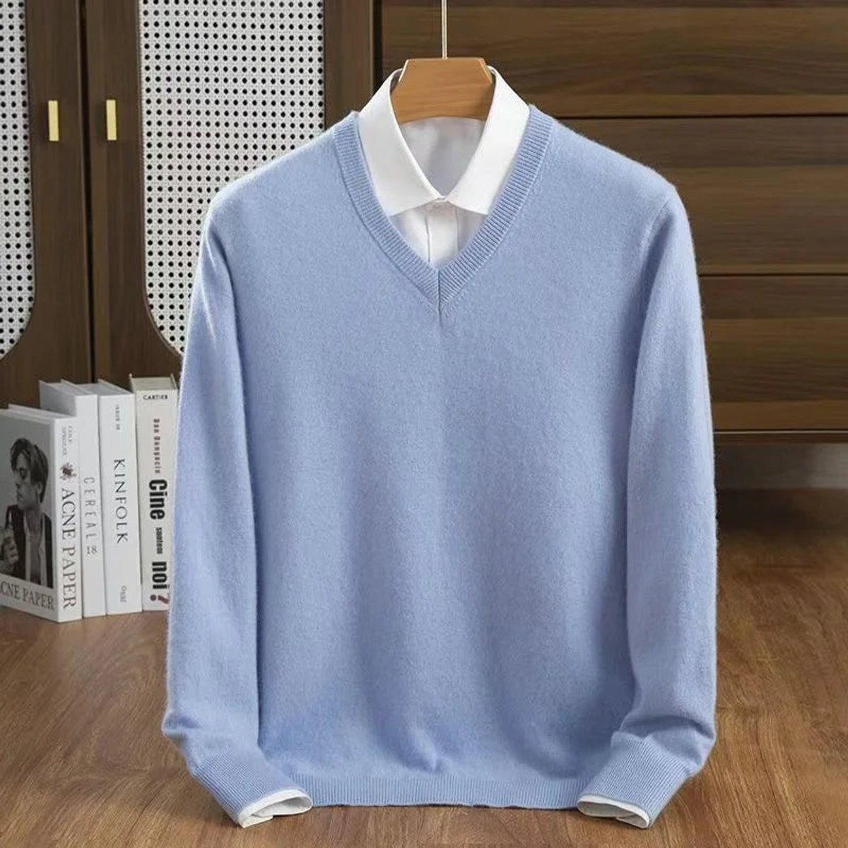 Sky blue V-neck cashmere jumper layered over a white collared shirt