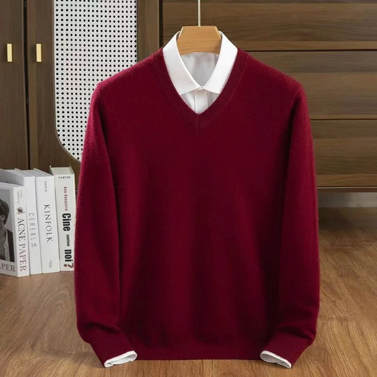 Burgundy V-neck knitted jumper layered over a white collared shirt