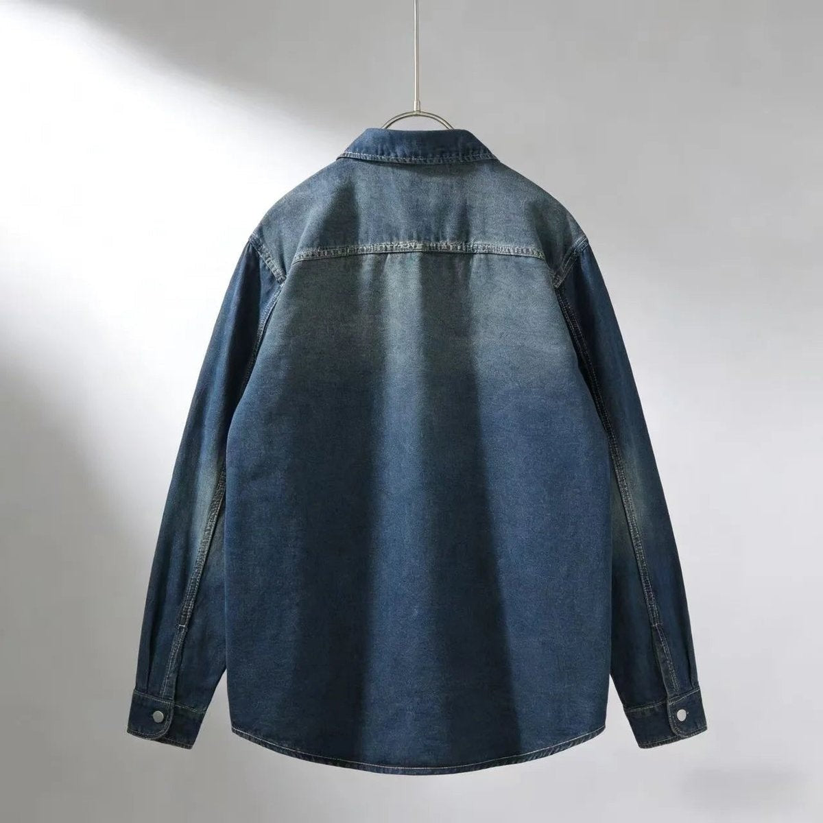 Back view of dark indigo denim overshirt with contrast stitching