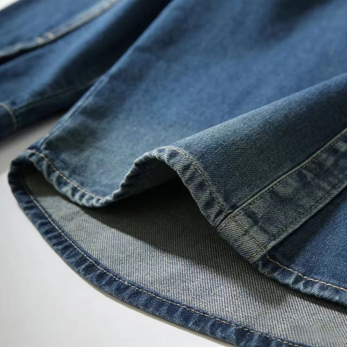 Close-up of denim overshirt hem showing contrast underside fabric