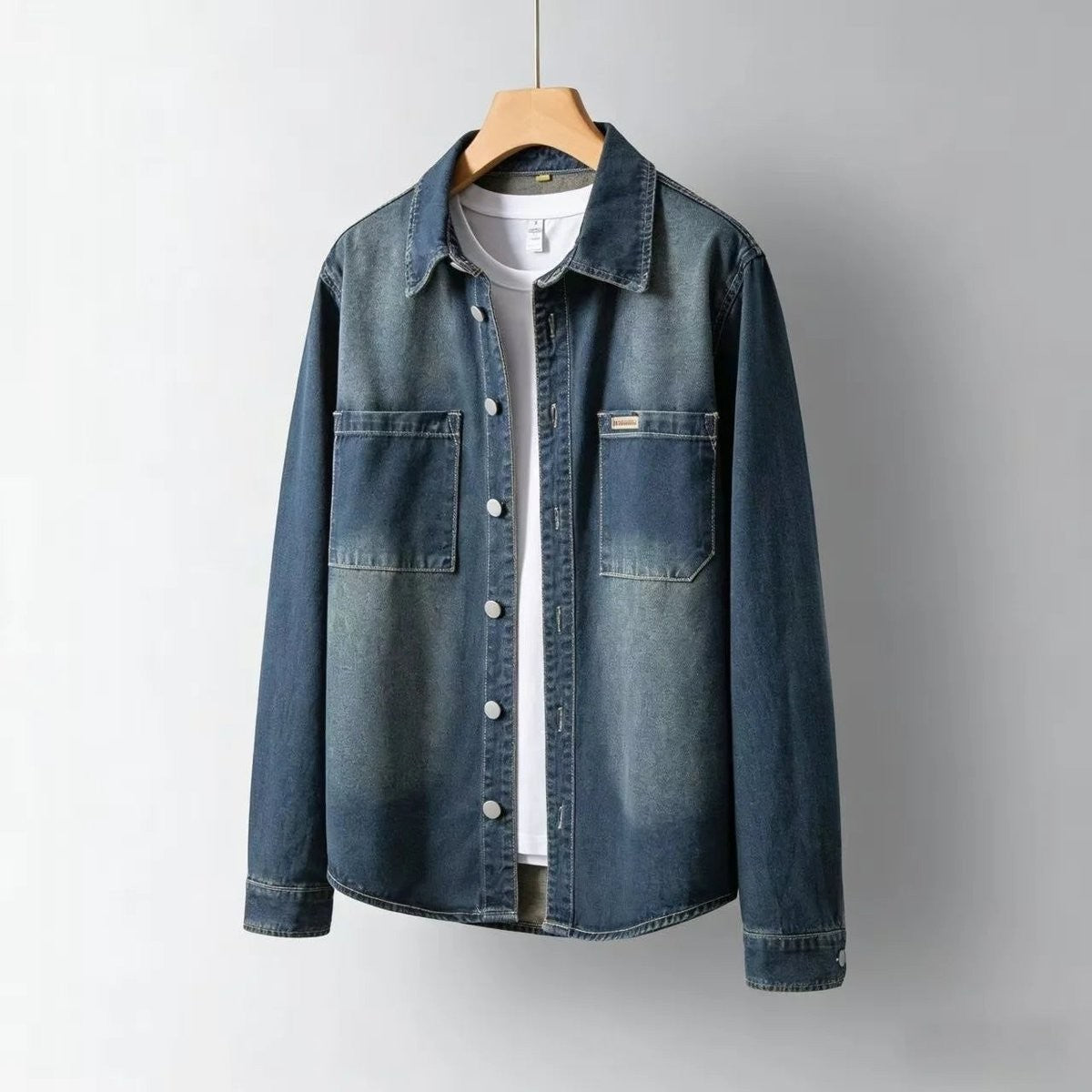 Dark denim overshirt hanging open over a plain white t-shirt