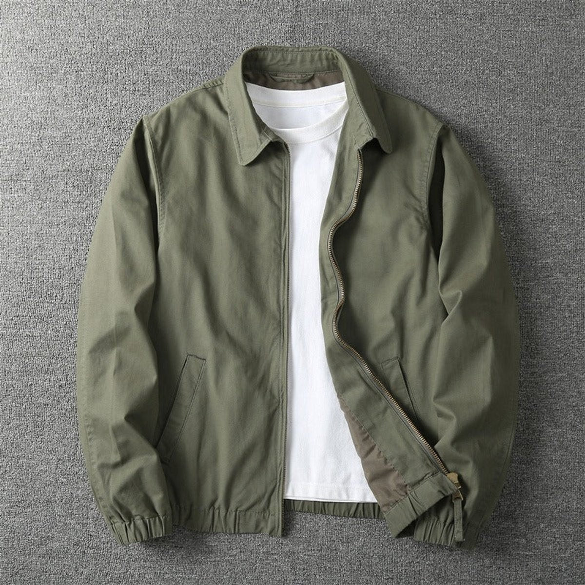 Khaki green zip-up bomber jacket featuring collared neck and elasticated hem