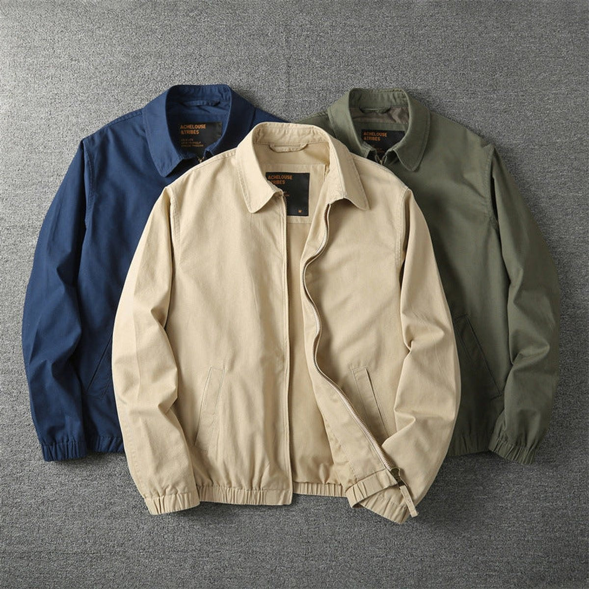 Three colourways of zip-up bomber jackets in navy, beige and khaki green