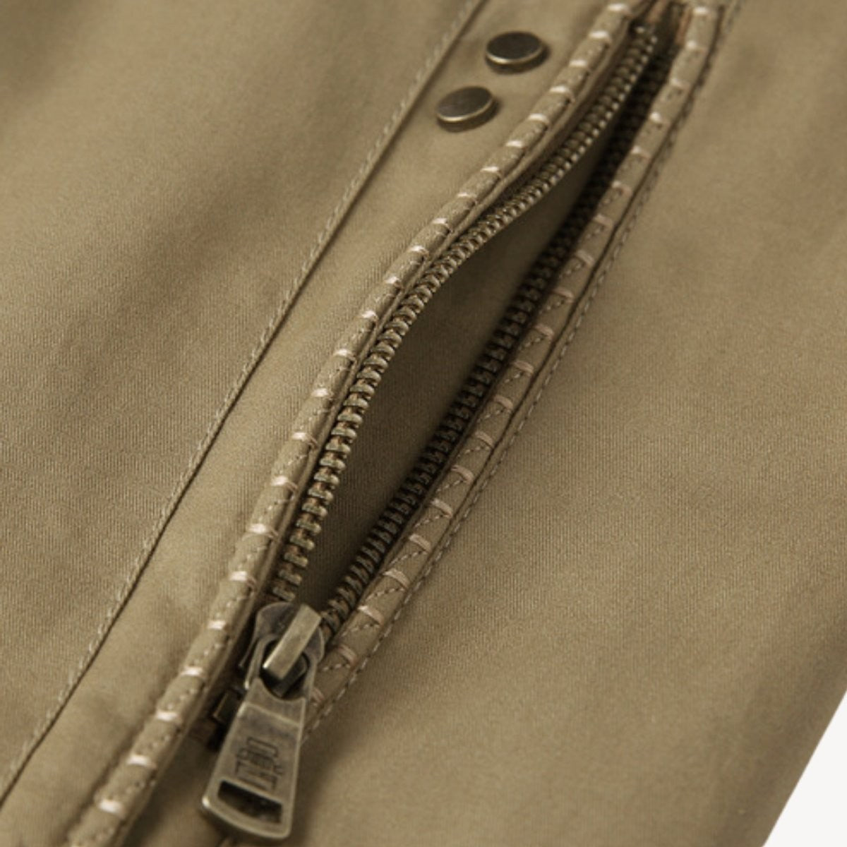 Close-up of zip pocket with popper fastening on khaki bomber jacket
