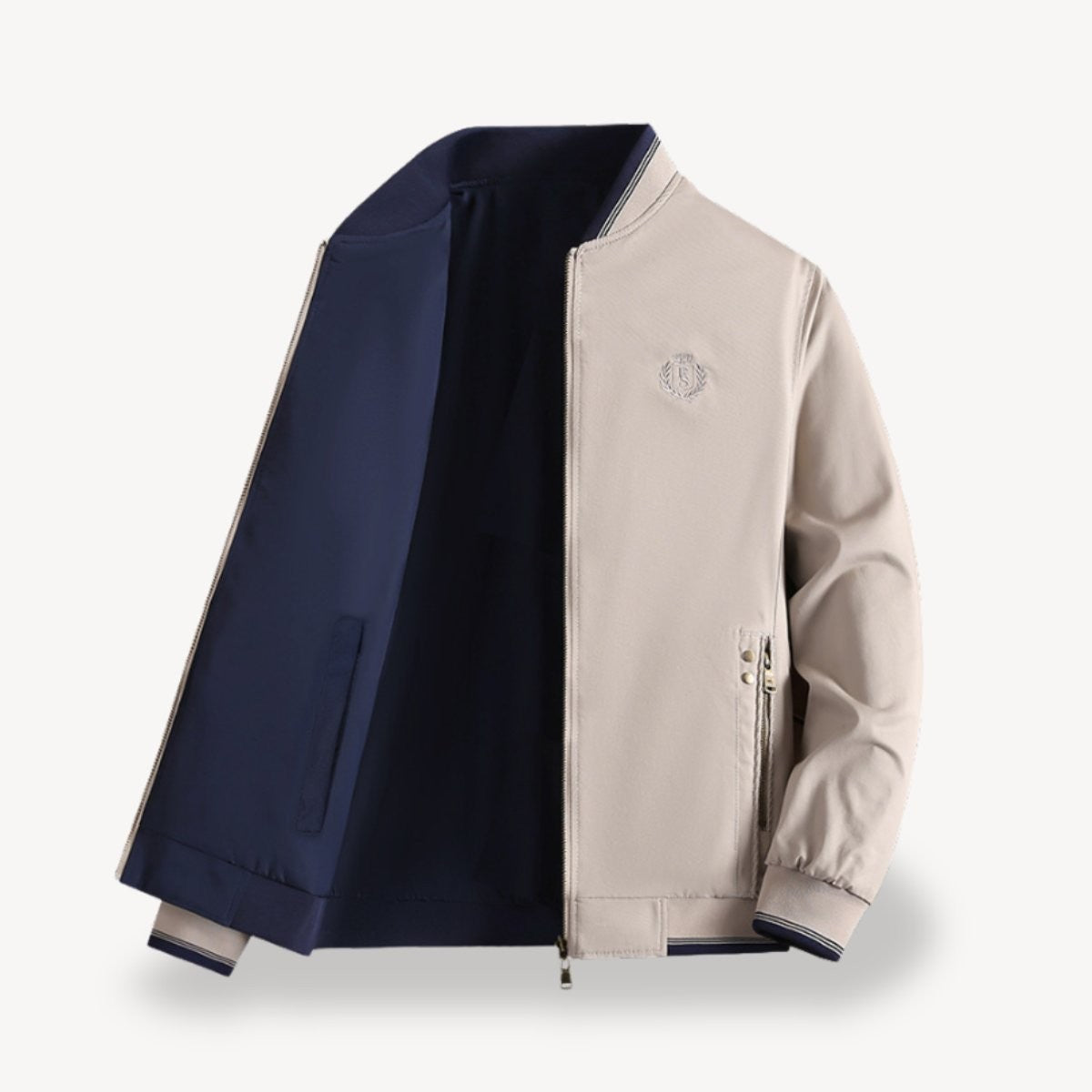 Stone-coloured bomber jacket open to show navy reversible lining