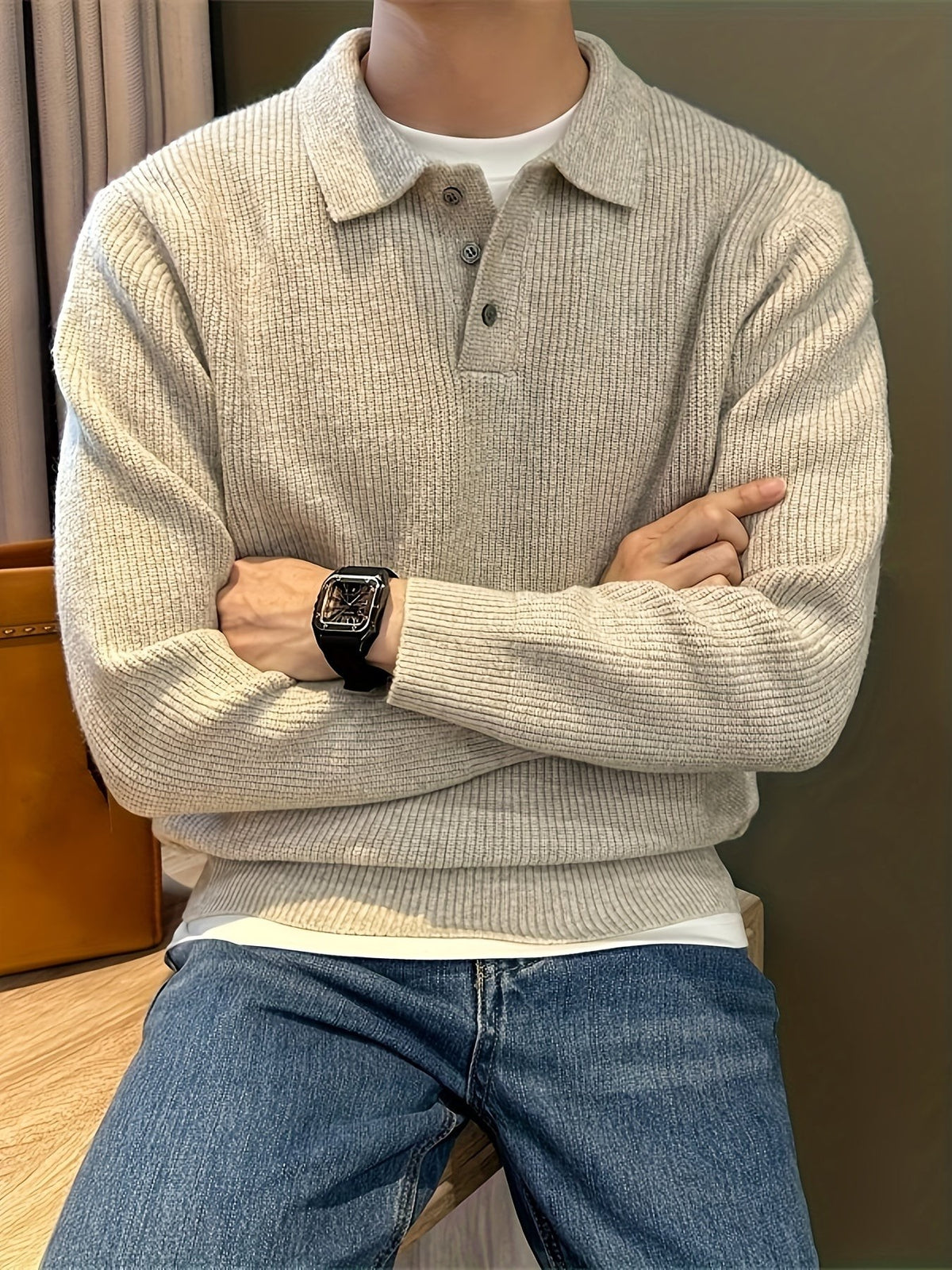 Men's oatmeal ribbed polo sweater layered over white t-shirt and jeans