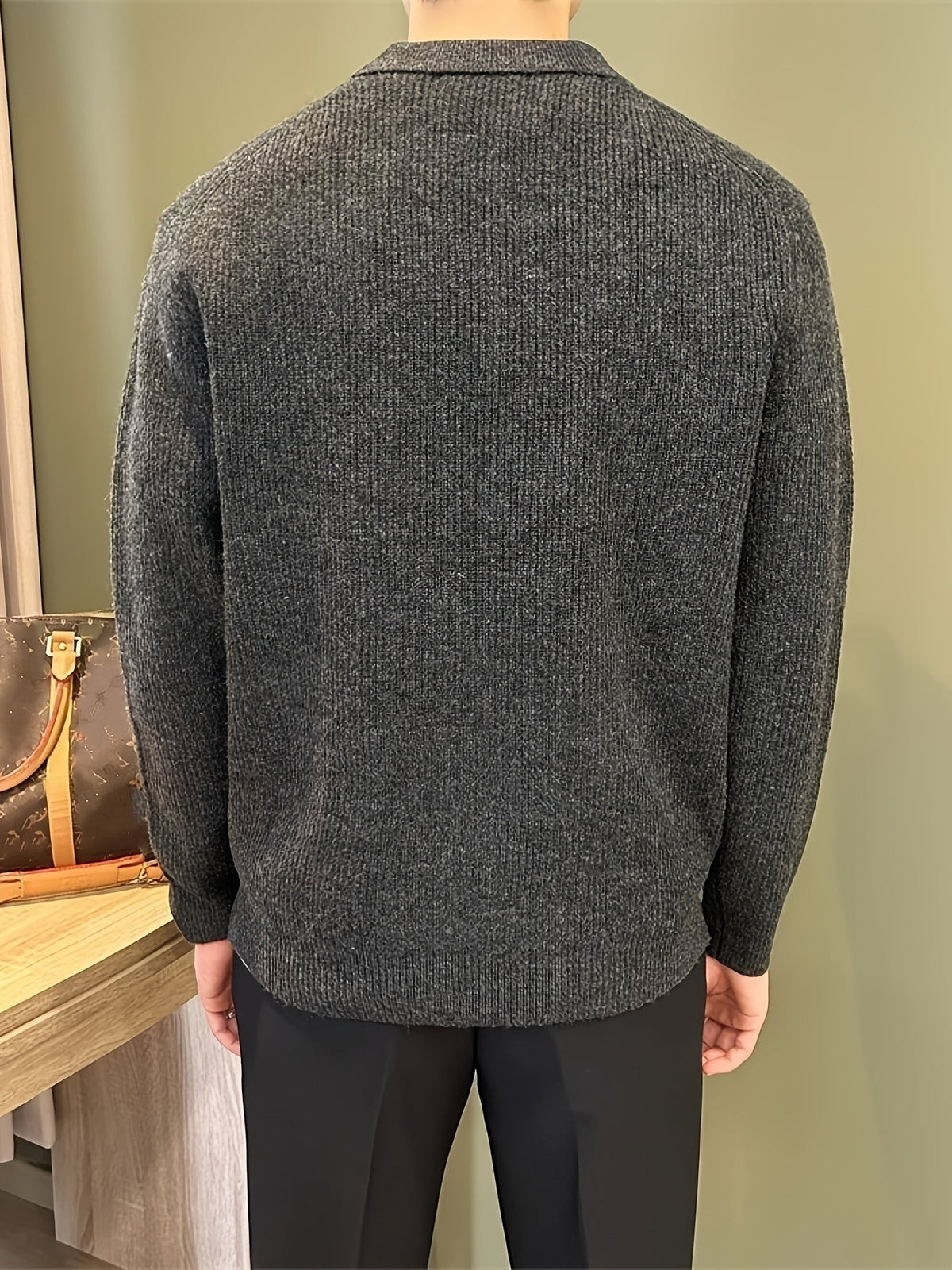 Back view of charcoal ribbed polo sweater highlighting knitted texture and fit