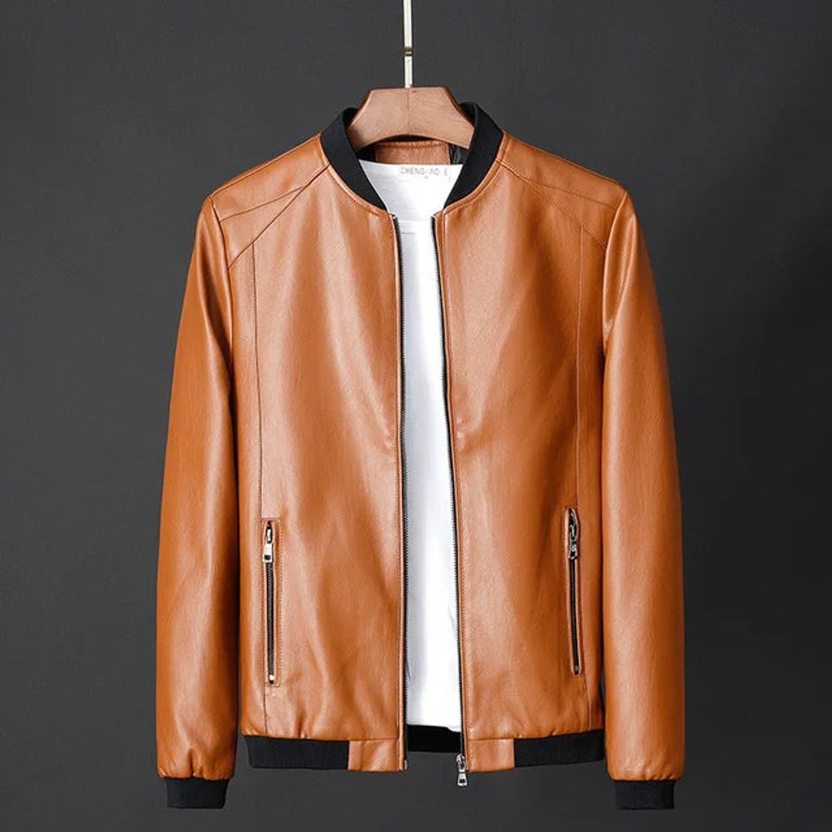 Tan faux leather bomber jacket with ribbed collar and zip pockets