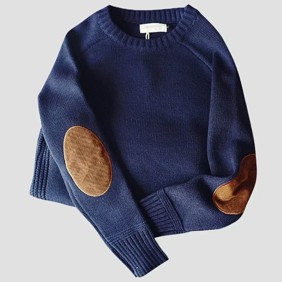 Navy blue crew neck jumper with tan suede elbow patches, flat lay