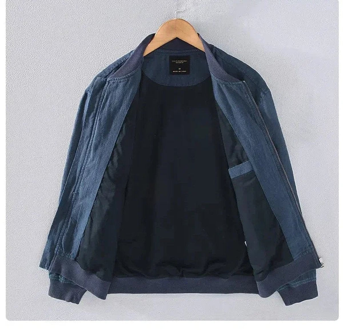 Inside view of navy bomber jacket showing lining and chest pocket