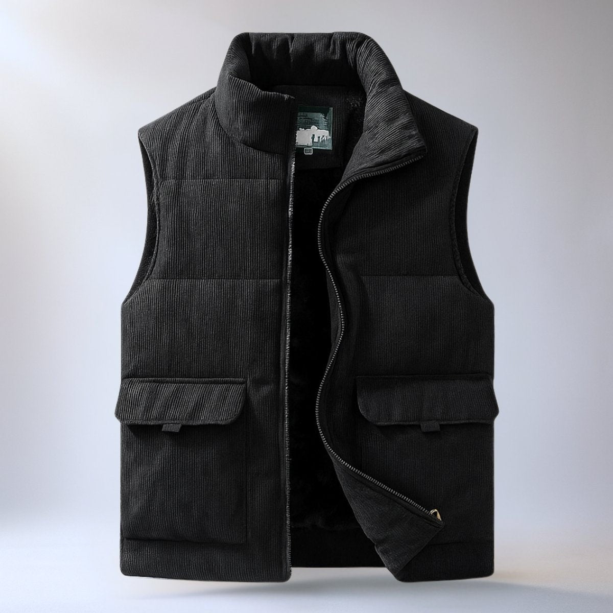 Black corduroy sleeveless gilet with flap pockets and zip fastening