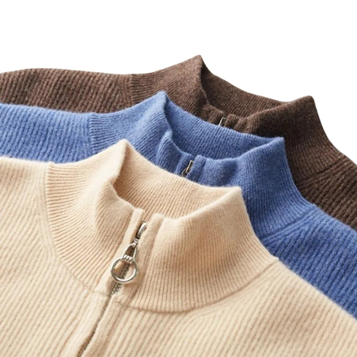 Close-up of ribbed stand-collar jumpers in cream, blue and brown cashmere knit