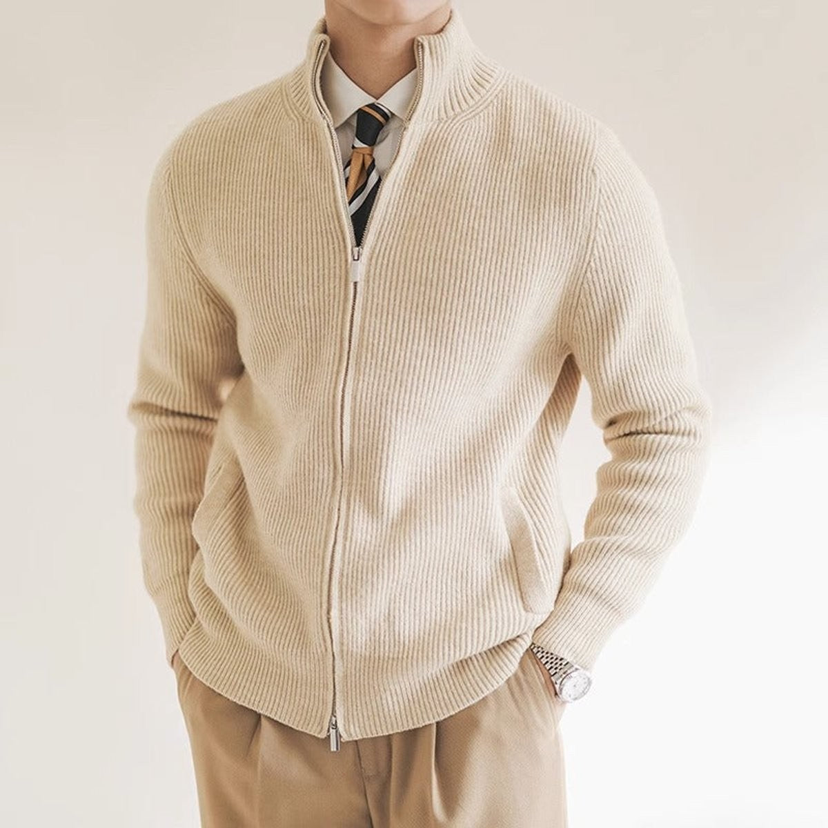 beige ribbed-knit full-zip cardigan worn with shirt and striped tie