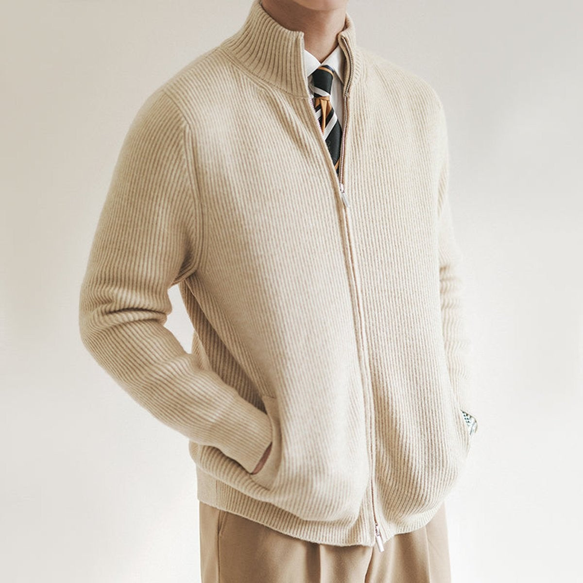 cream ribbed-knit stand-collar cardigan jumper styled with tailored trousers