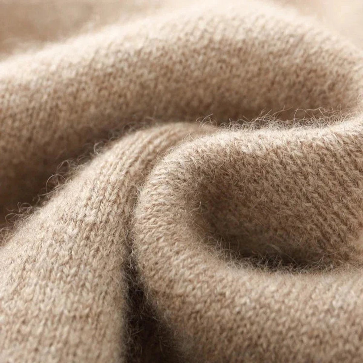 Macro shot of soft beige cashmere knit fabric texture