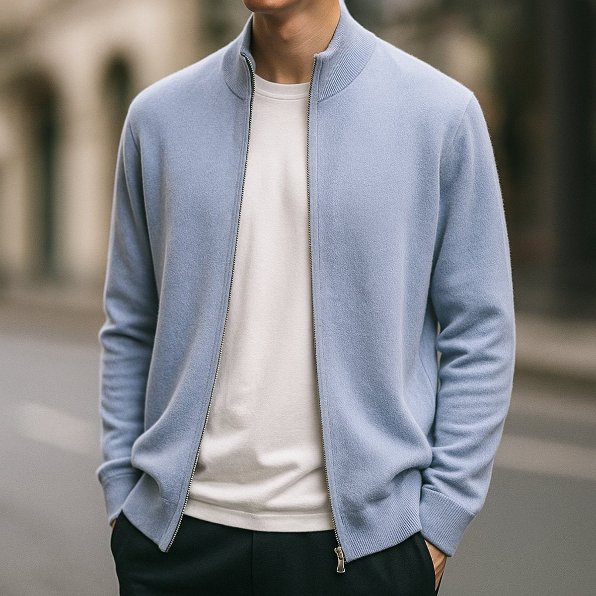 Man wearing light blue zip-up knitted cardigan on city street