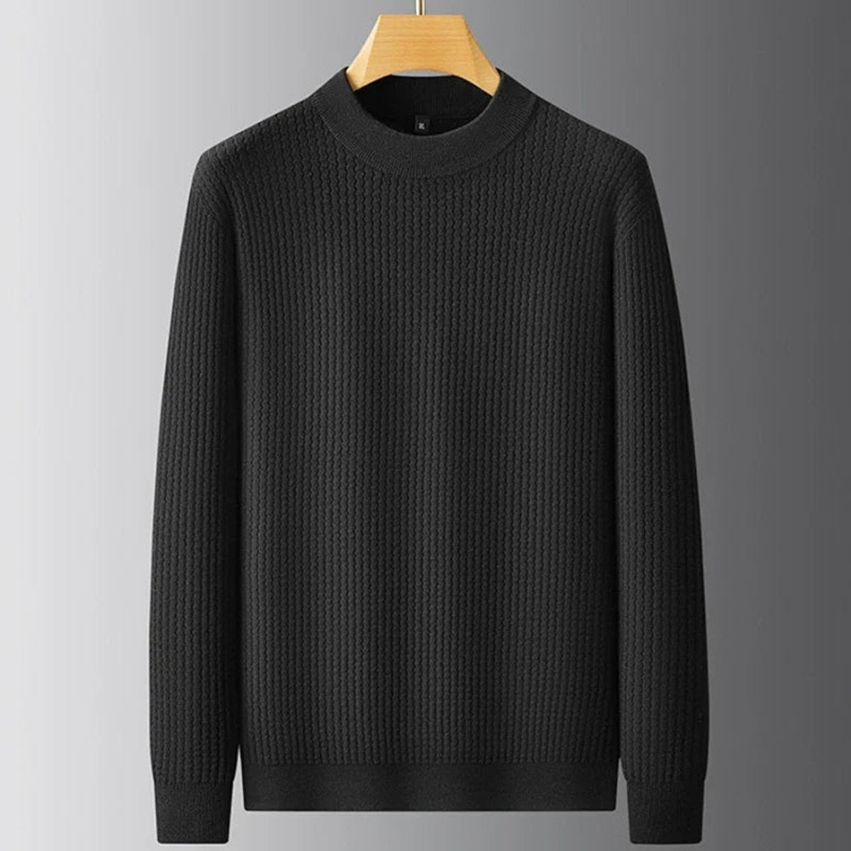 Black ribbed knit crew neck jumper hanging against grey background