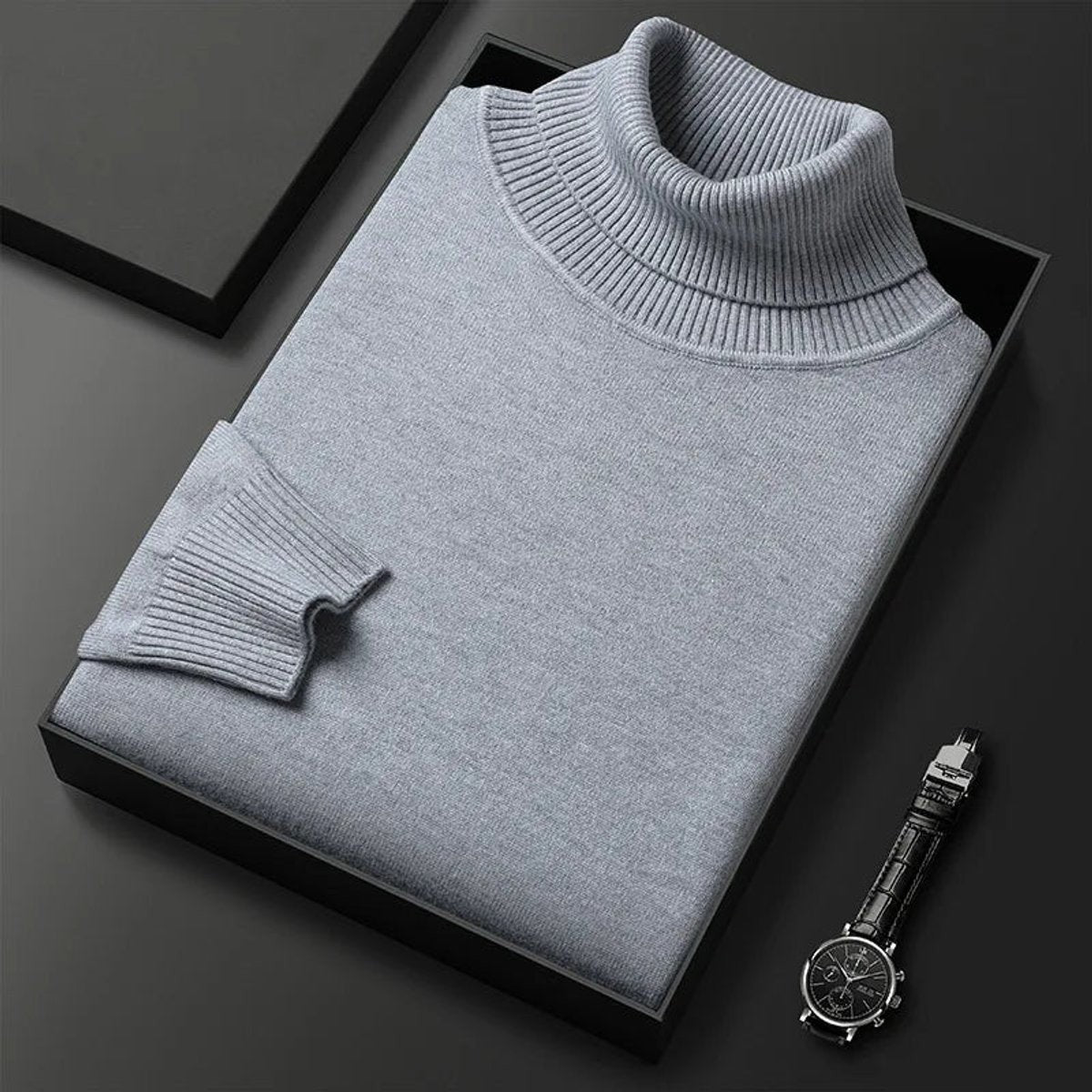 Folded grey turtleneck jumper showing ribbed knit texture