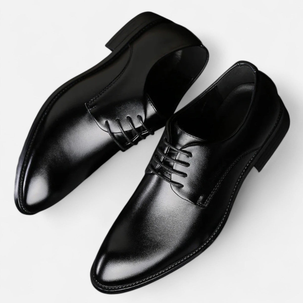 Pair of black leather lace-up shoes displayed in top-down view