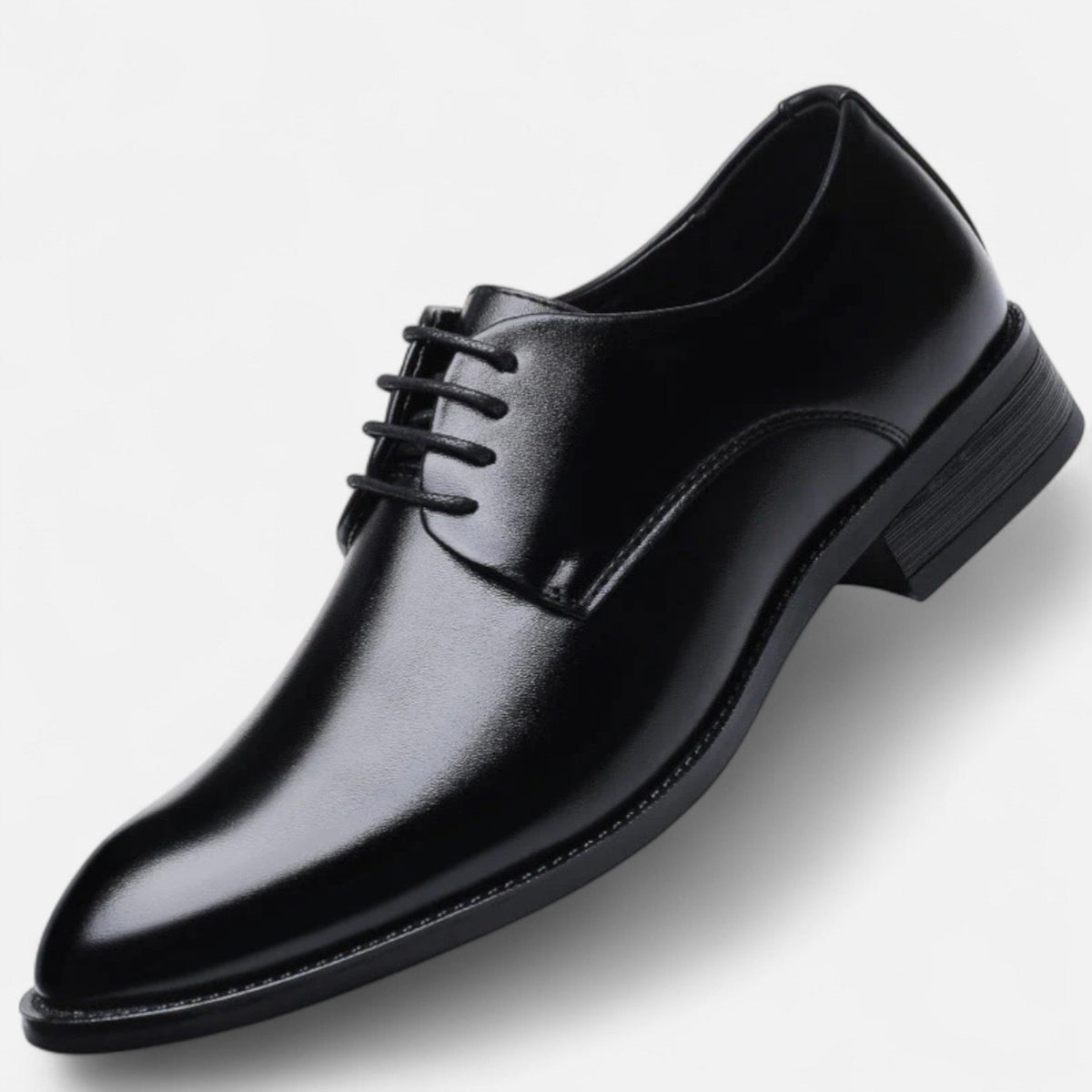Tan leather formal shoe with pointed toe shown at an angled view