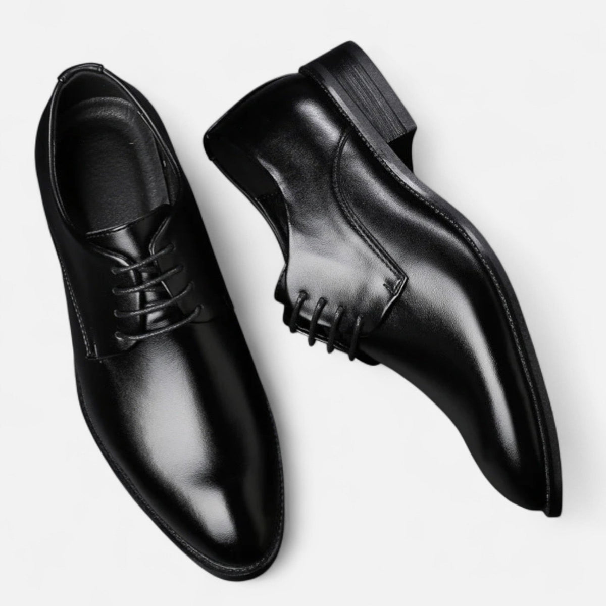 Pair of tan leather lace-up dress shoes viewed from above