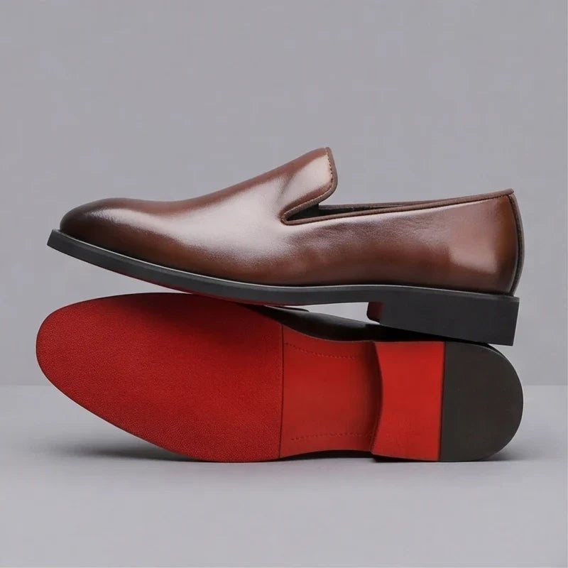 Side profile of brown leather loafer stacked above matching red sole