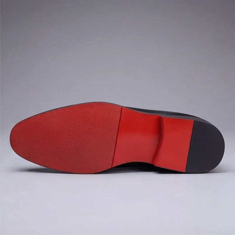 Close-up of red rubber sole on black leather men's loafer