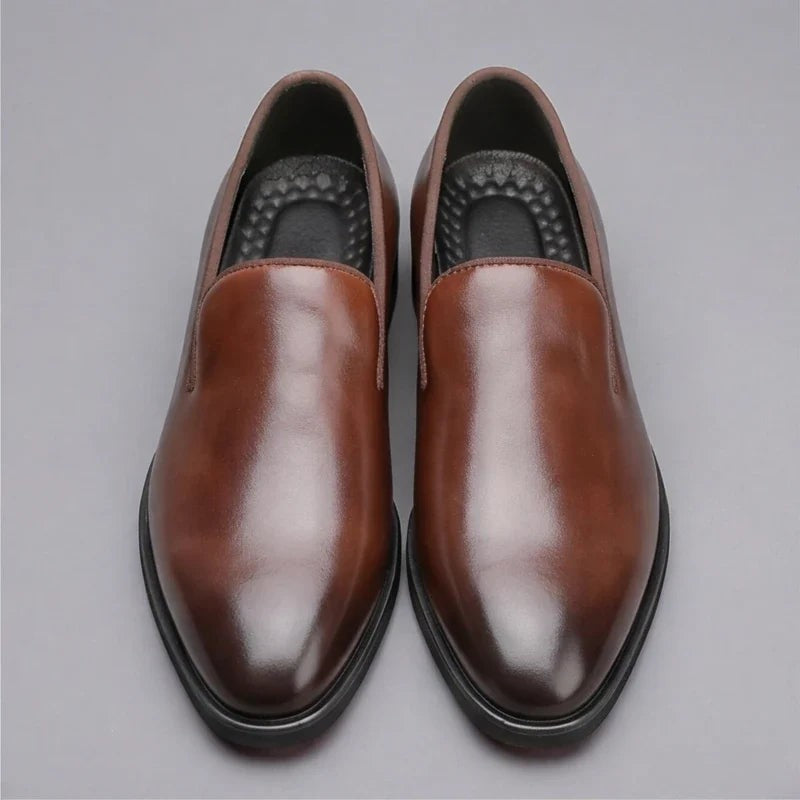 Top-down view of brown leather slip-on loafers with cushioned insole