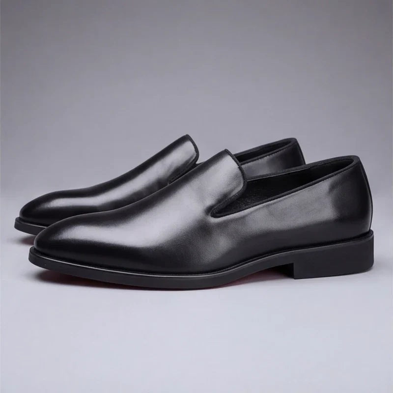 Black leather loafers with pointed toe and red rubber sole